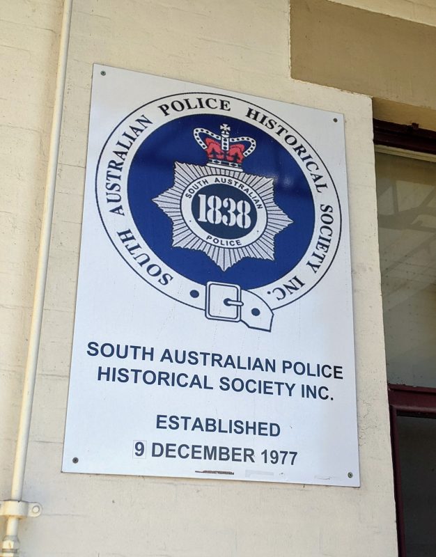 A sign reading "South Australian Police Historical Society Inc. Established 9 December 1977"
